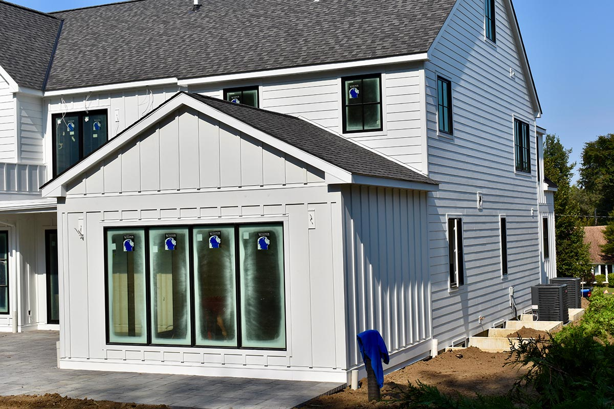 white fibre cement siding installation on a home.